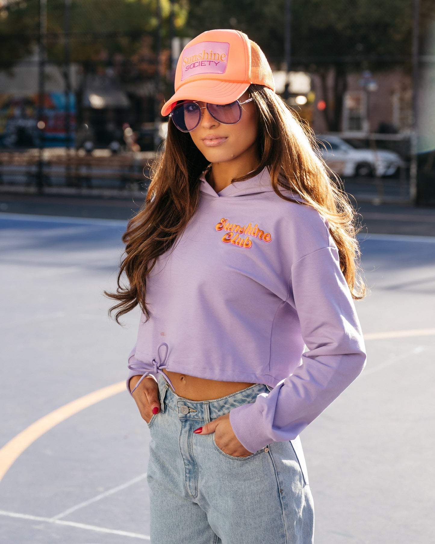 Grace Ann Nader in Sunshine Society Trucker Hat, Orange