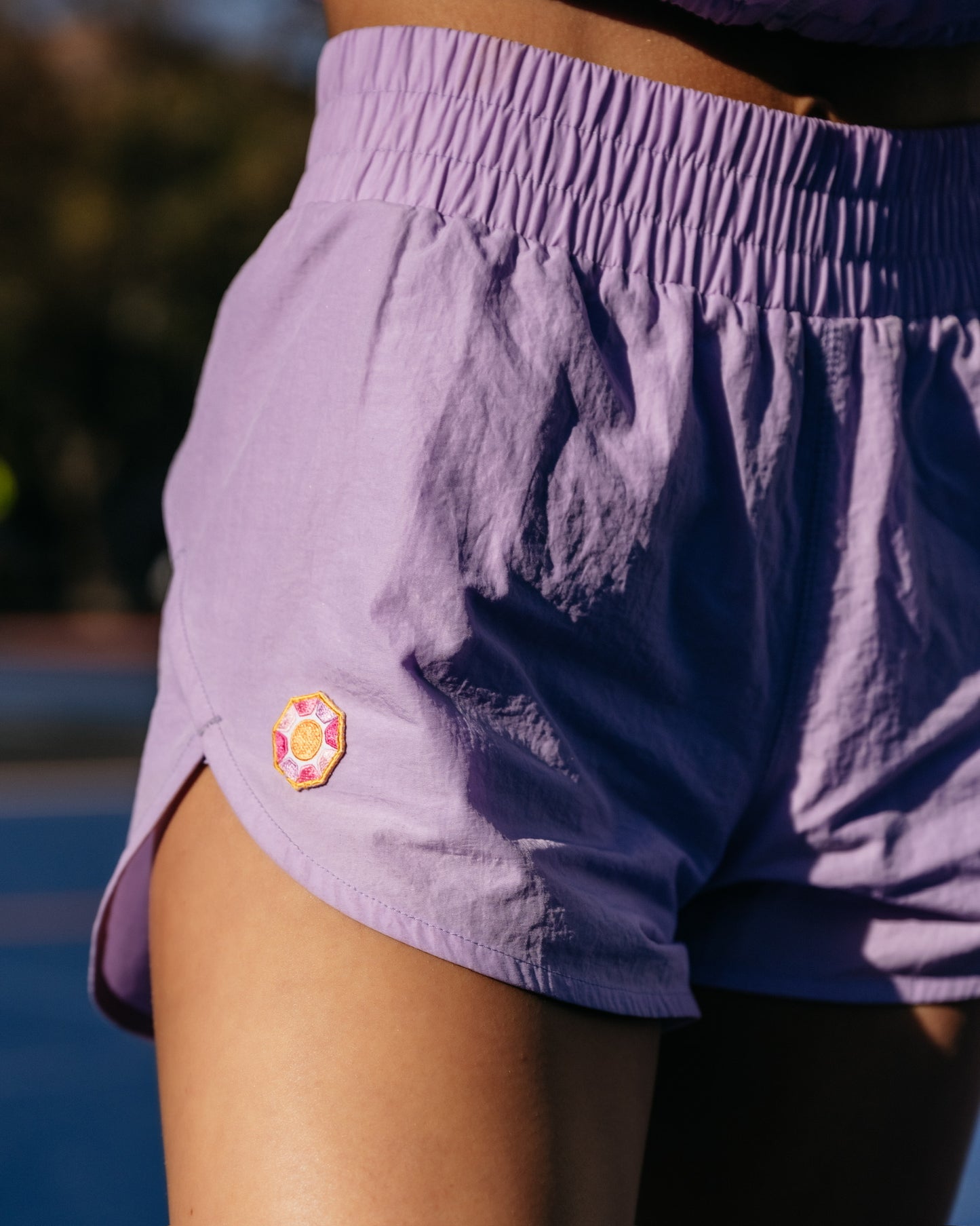 Grace Ann Nader in Solitaire Sun Track Shorts, Purple