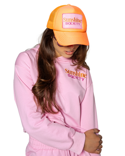 Grace Ann Nader in Sunshine Society Trucker Hat, Orange